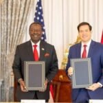 Kenya and United States officials hold signed trade agreement documents during bilateral meeting