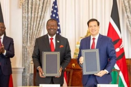 Kenya and United States officials hold signed trade agreement documents during bilateral meeting