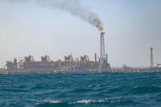 Offshore oil rigs at Senegal’s Sangomar field with sunset backdrop, representing record 2025 oil output