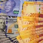 South African rand notes with stock market chart showing currency fluctuation
